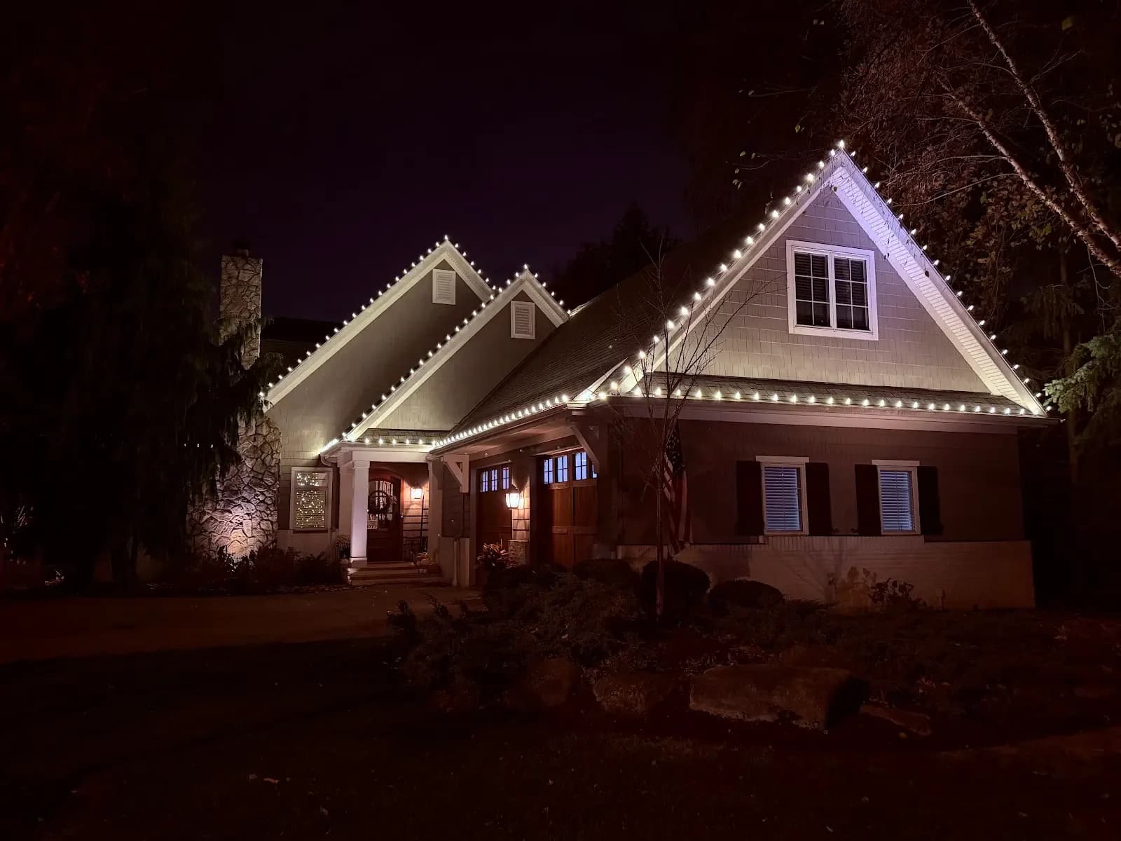 Warm lights outlining the front gables in Avon Lake, a Shoreline project