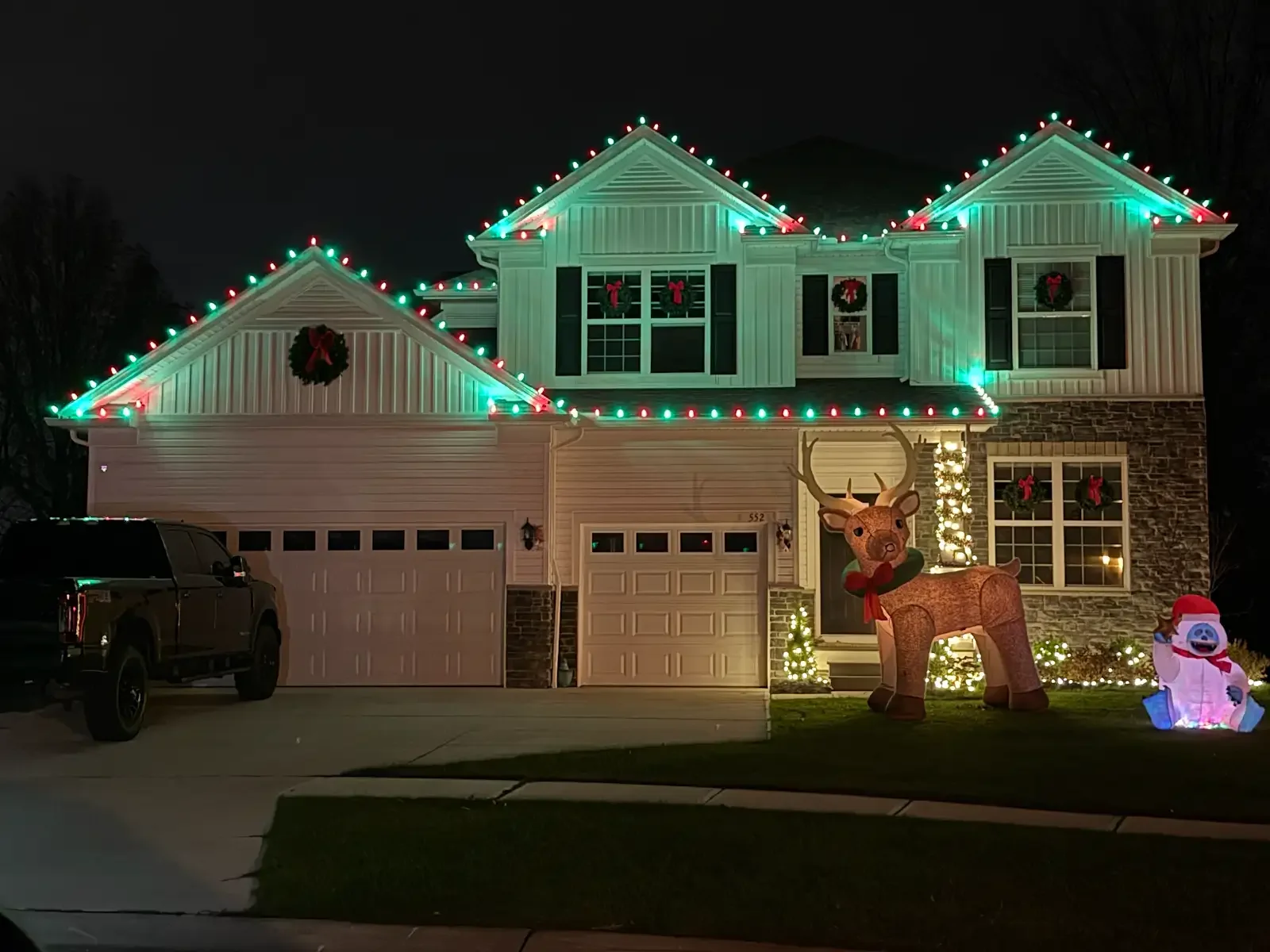 Green and red holiday roofline lights in Avon Lake, a Shoreline project