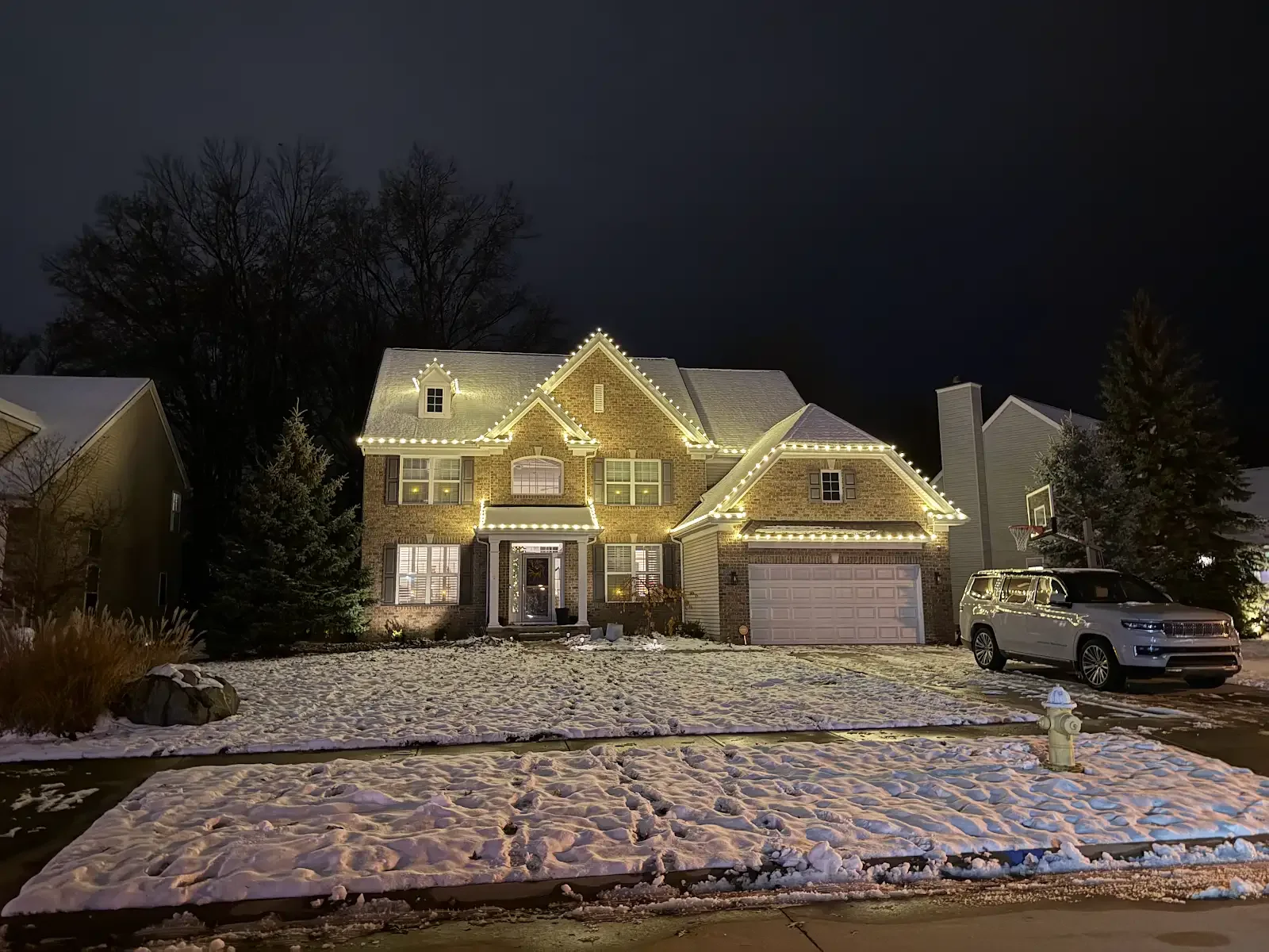 Illuminated home on a snowy evening in Avon Lake, a Shoreline project