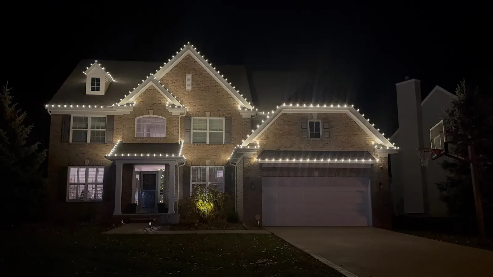 Warm lighting along multiple rooflines in Avon Lake, a Shoreline project