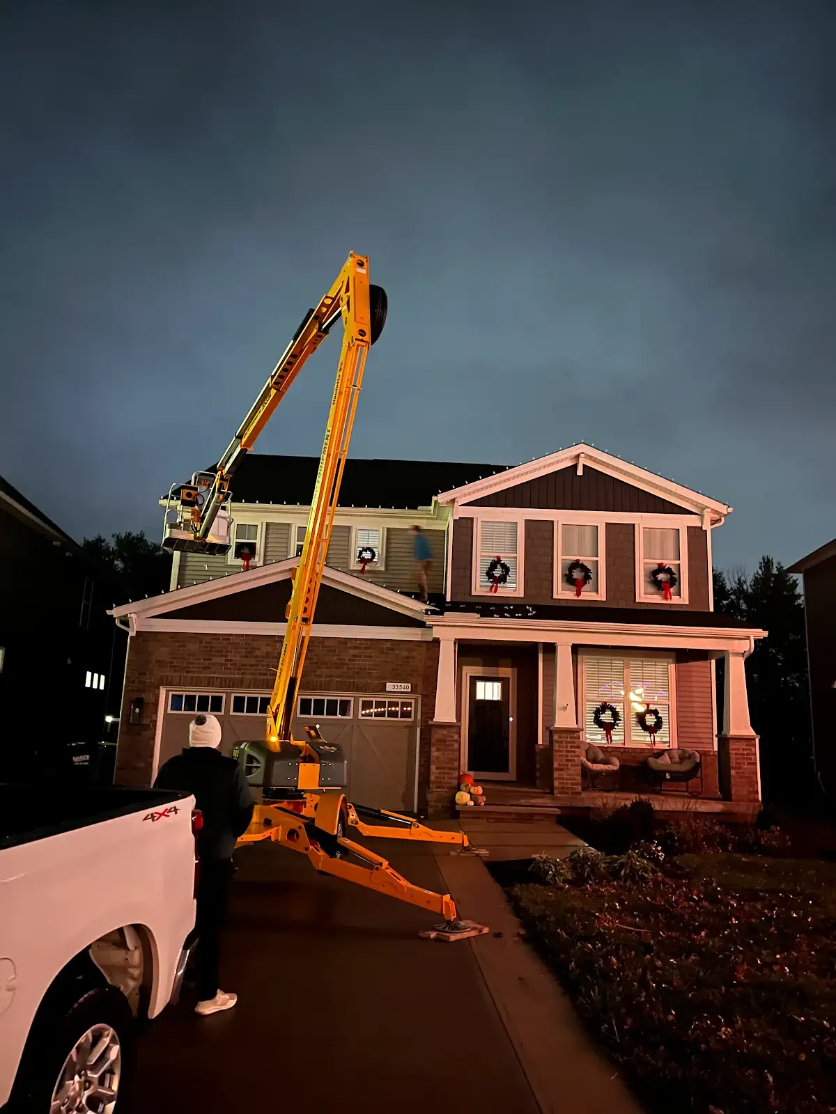 Lighting installation in progress with a lift in Avon Lake, a Shoreline project
