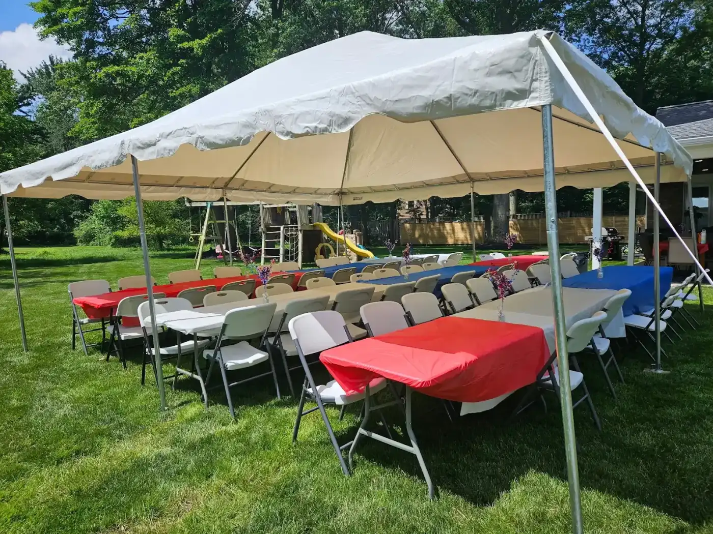 Tent seating with red and blue table covers in Avon, a Shoreline project