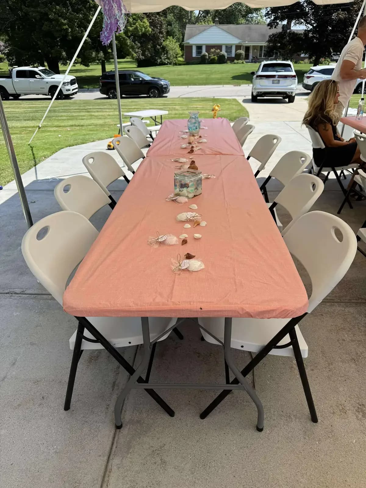 Long table and chairs beneath the tent in Independence, a Shoreline project