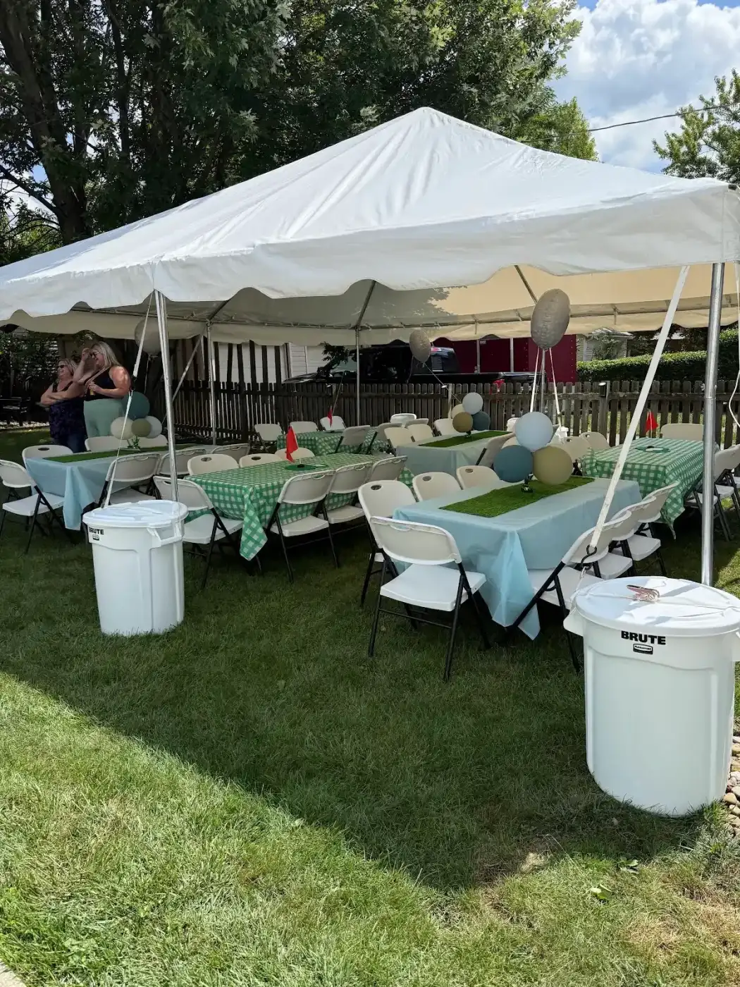 Tables and chairs beneath the backyard tent in Lakewood, a Shoreline project