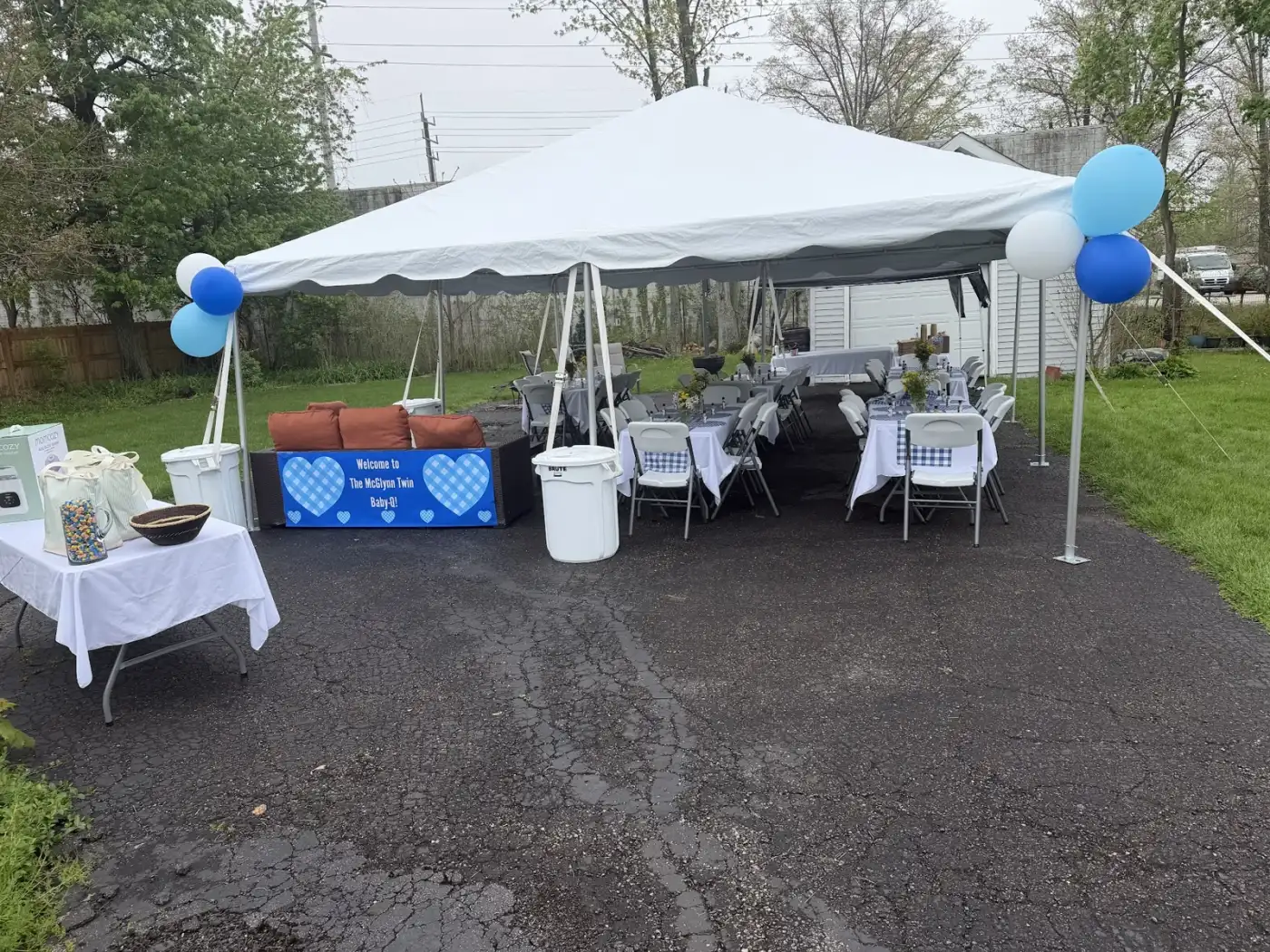 White tent with tables, chairs and blue balloons at a Westlake gathering, installed by Shoreline